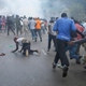 Protesters running from police.